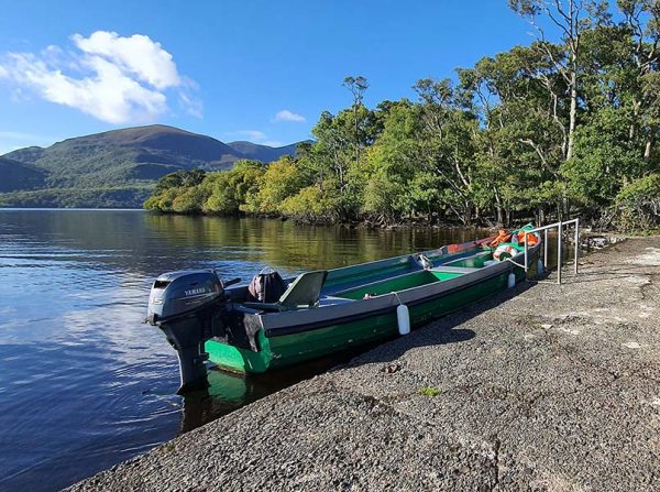 Lakes of Killarney Boat Tours traditional boat with view of Kerry Mountains